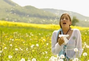 getty_woman_sneezing_in_flowering_meadow